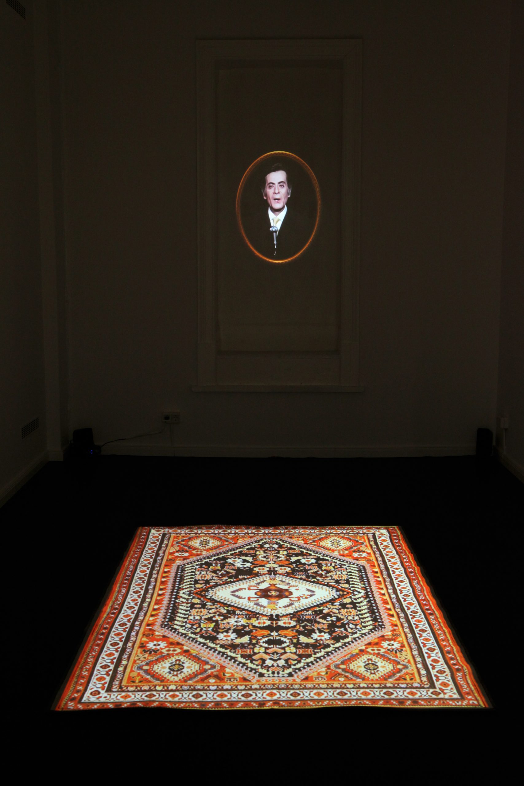 "Alashan Maleish Gherak",
2011,
two-channel video installation with a single-channel projection on manipulated tapestry gilded in
wooden frame, and a single channel animation projection on a floor rug, stereo sound, 
duration 06:00 min, 
oval frame dimensions 60 cm x 50 cm, 
dimensions variable