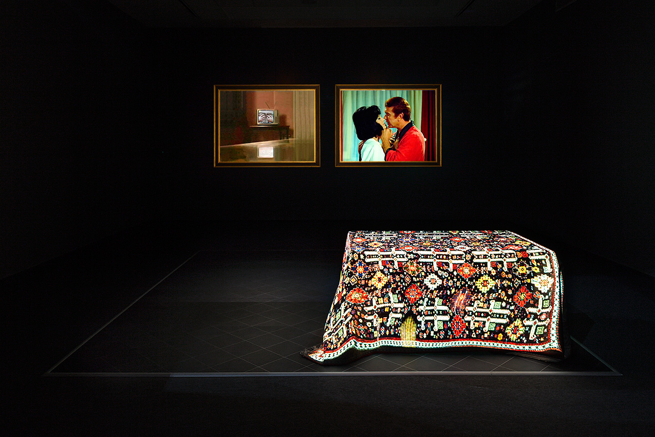 "The Concert", 
2013,
4-channel video installation, two projections on a large carpet covering a dinning table,
two projections on two screens in gilded wooden frame, linoleum floor, stereo sound,
 duration 12:38 min, dimensions variable