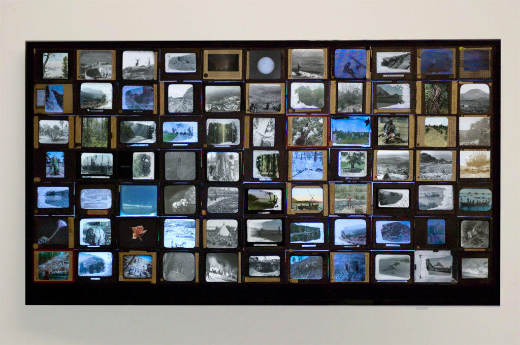 Dana Levy, History Lessons, 2022, 50” LED screen with 77 antique magic lantern slides mounted on top; single-channel video.