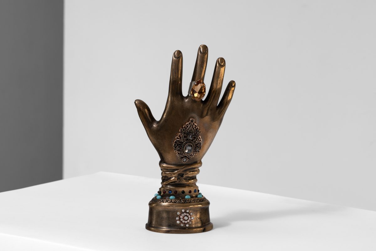 Elena Ceretti Stein, Hand of Saint, 2022, Bronze, glass, mirror, metal jewelry, amber crystal, acrylic, 27 x 14 x 8 cm. Photo by Daniel Hanoch